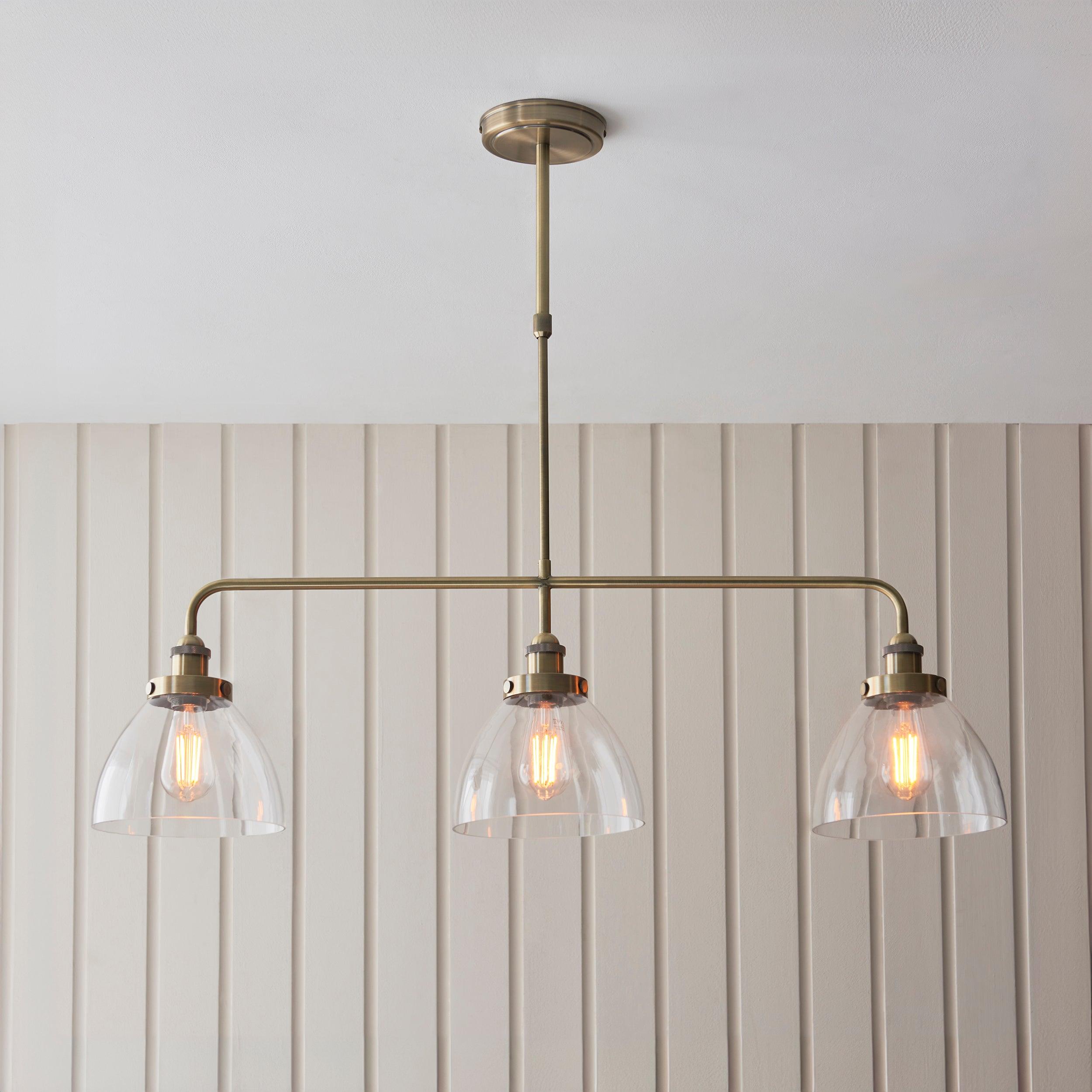 hansen linear 3 light brass pendant glass shades by Endon Lighting Living room close up image