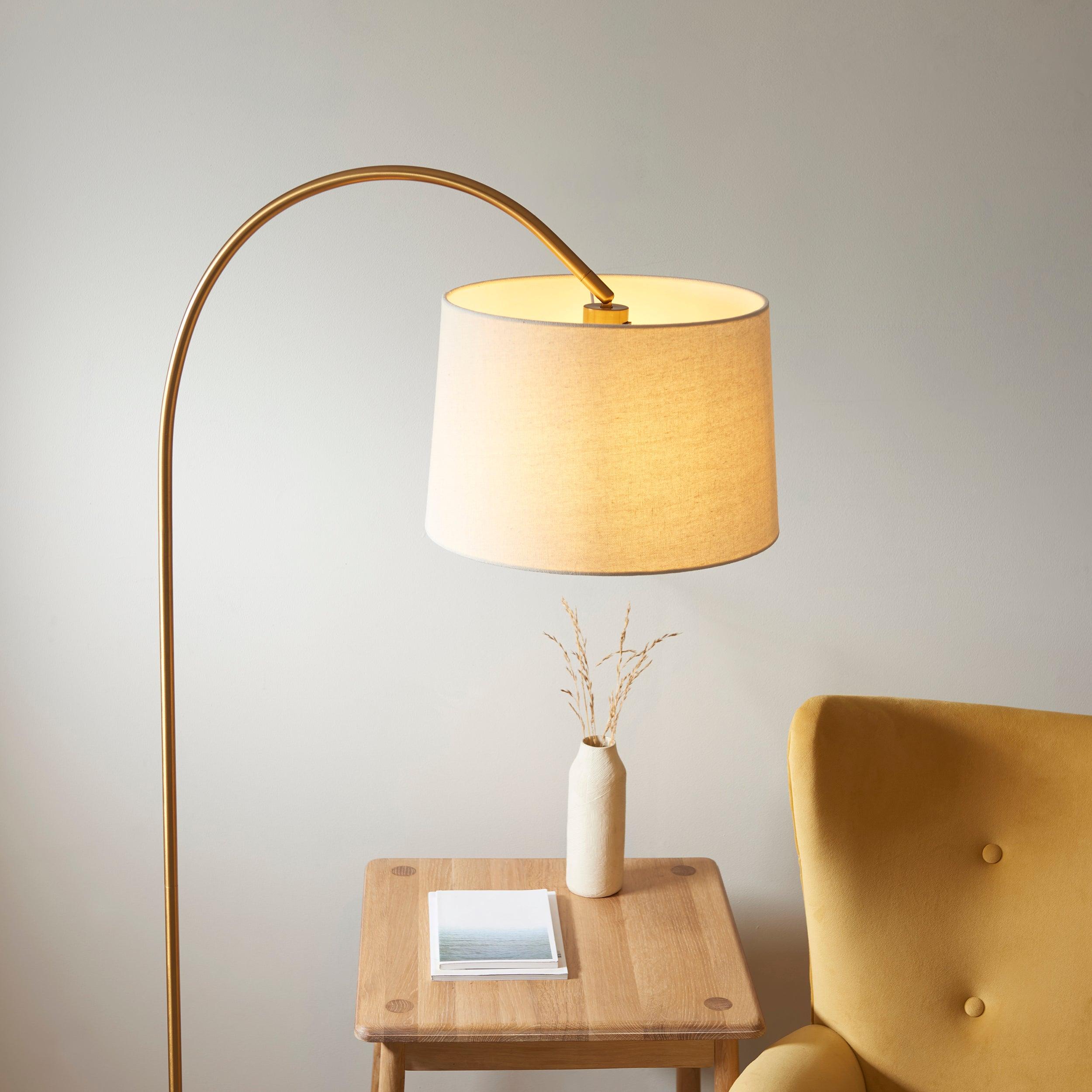 carlson brass modern floor lamp natural shade by Endon Lighting Living room close up image