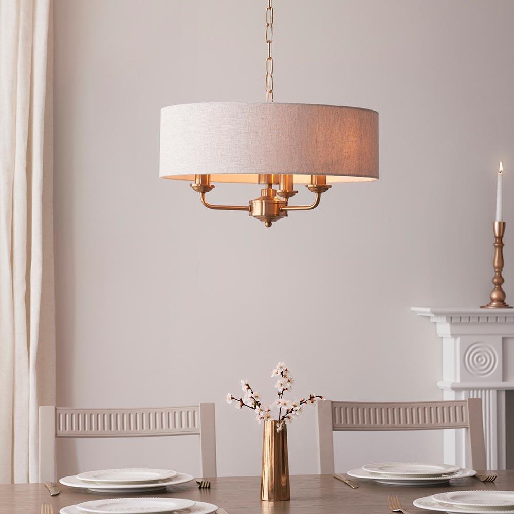 highclere aged brass 3 light pendant natural linen shade by Endon Lighting Living room close up image