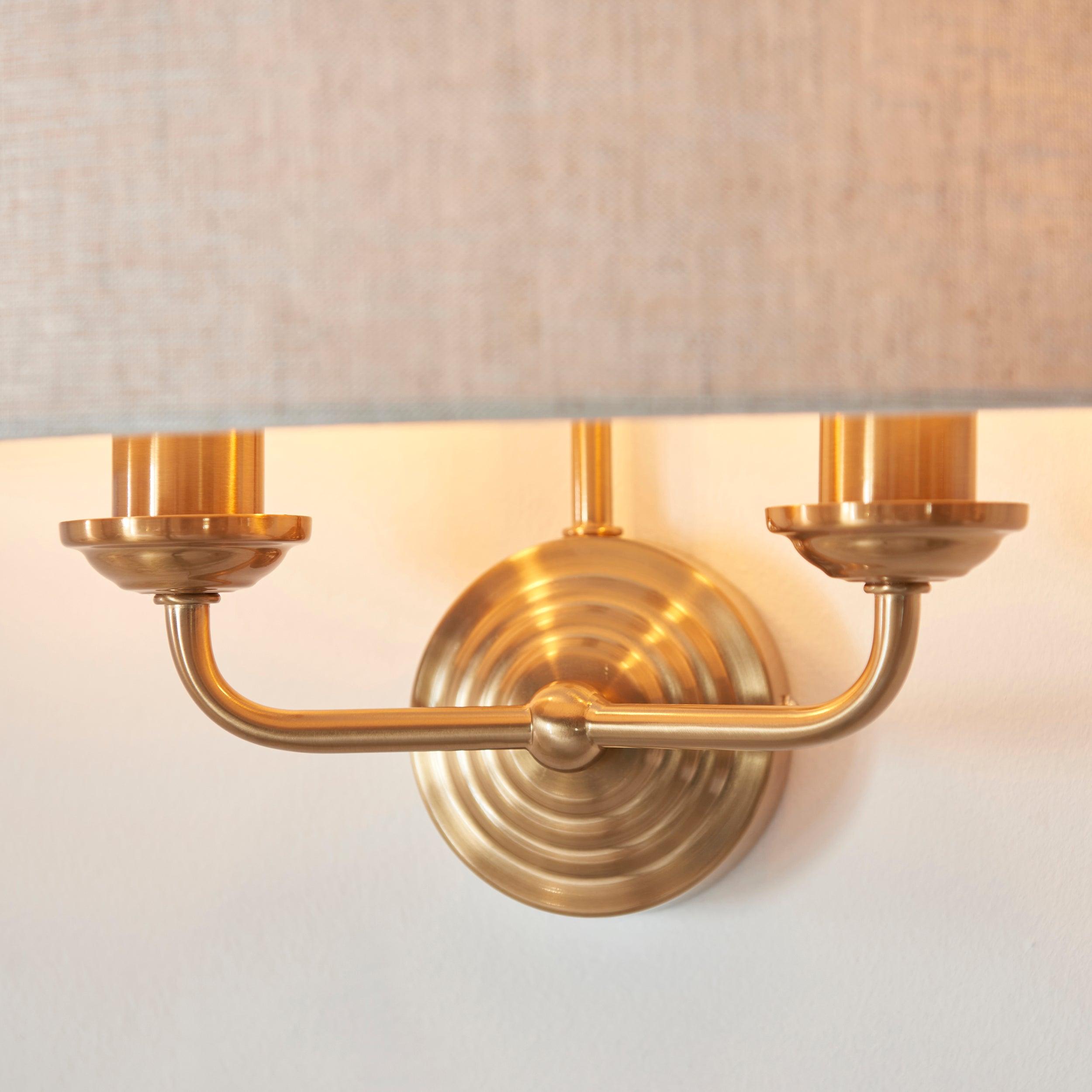 highclere brass wall light natural linen shade by Endon Lighting Bedroom Close Up Image