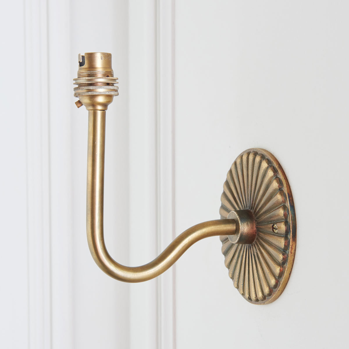 Reverse-angle view of the Dahlia Swan wall light, swan-neck arm curving away from the fluted backplate