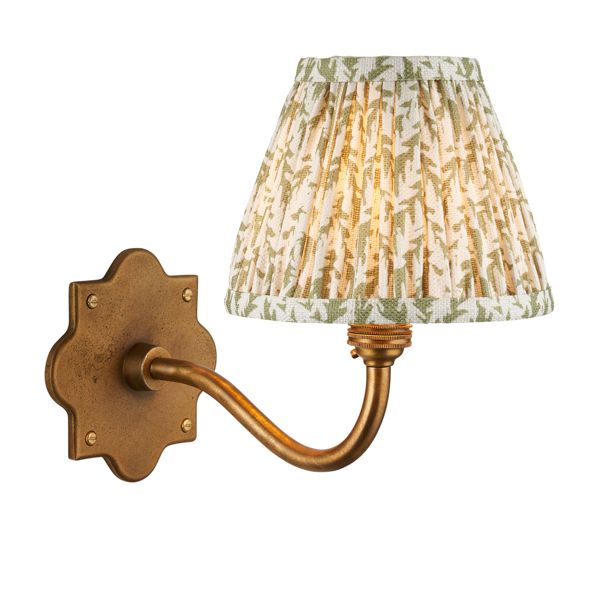 Anvil Curve antique brass wall light with green leaf-print pleated shade, studio shot on white
