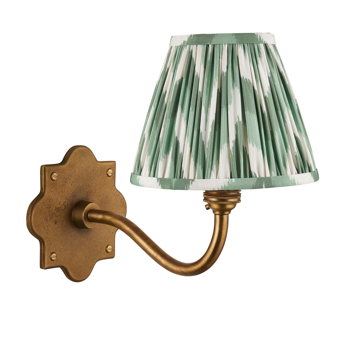 Anvil Curve antique brass wall light with green zigzag ikat shade, plain white studio shot