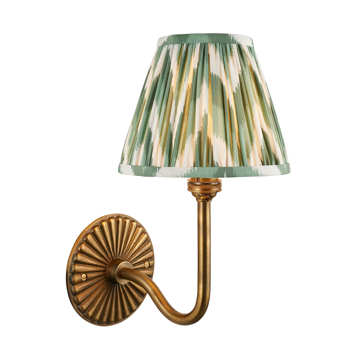 Dahlia Swan antique brass wall light with green zigzag ikat pleated shade on white background