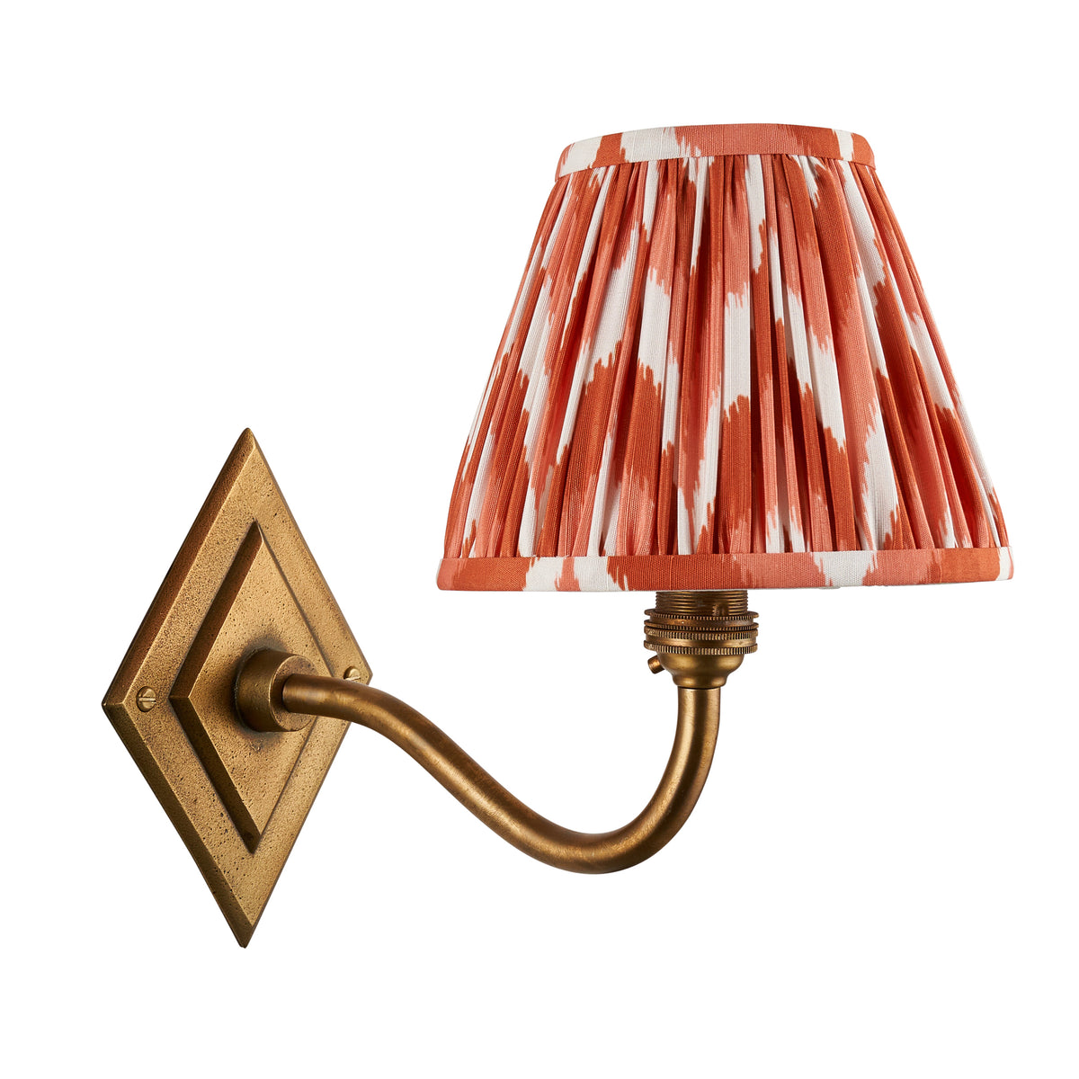 Diamond Curve antique brass wall light with orange zigzag pleated shade on a white background