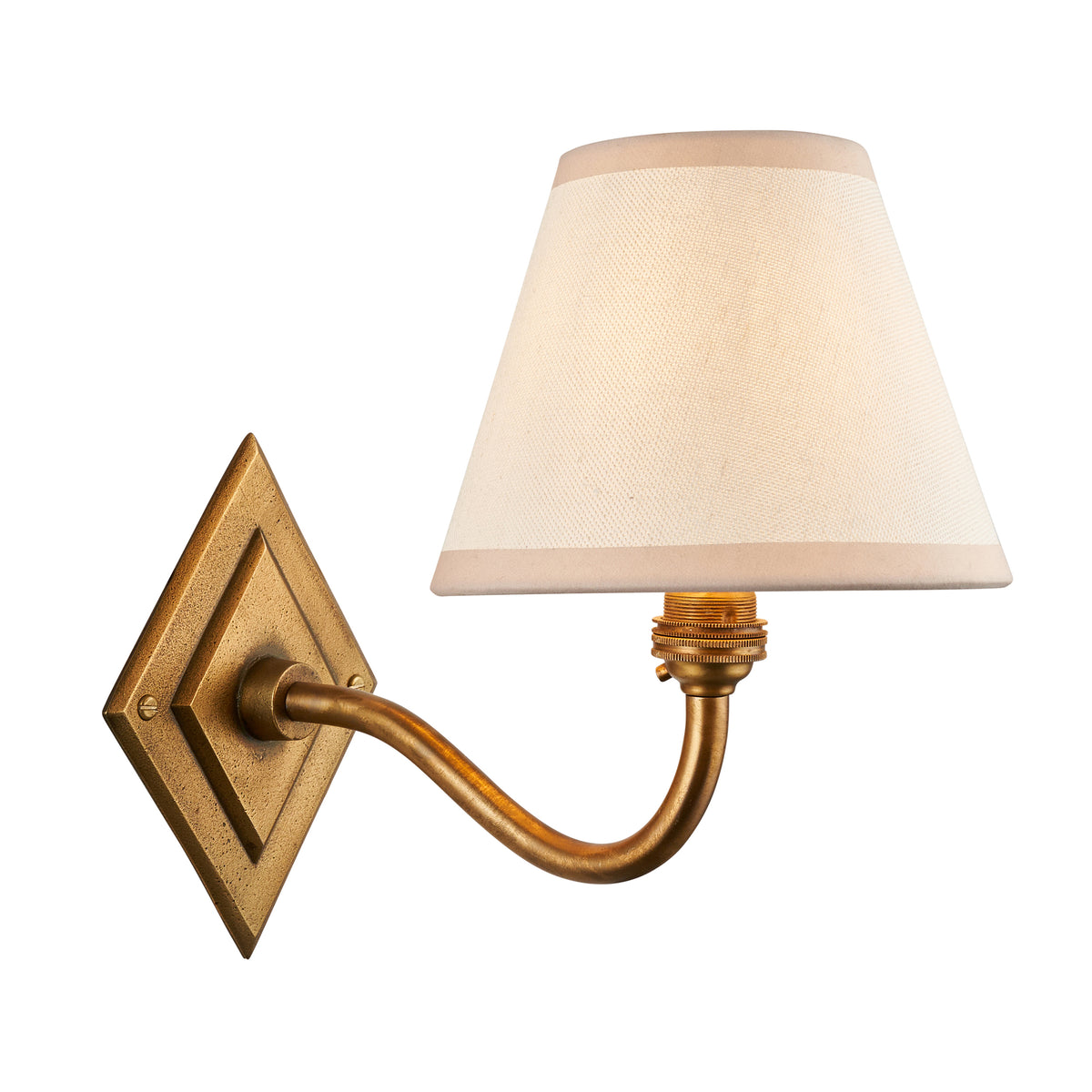 Diamond Curve antique brass wall light with a tapered white fabric shade on a diamond backplate