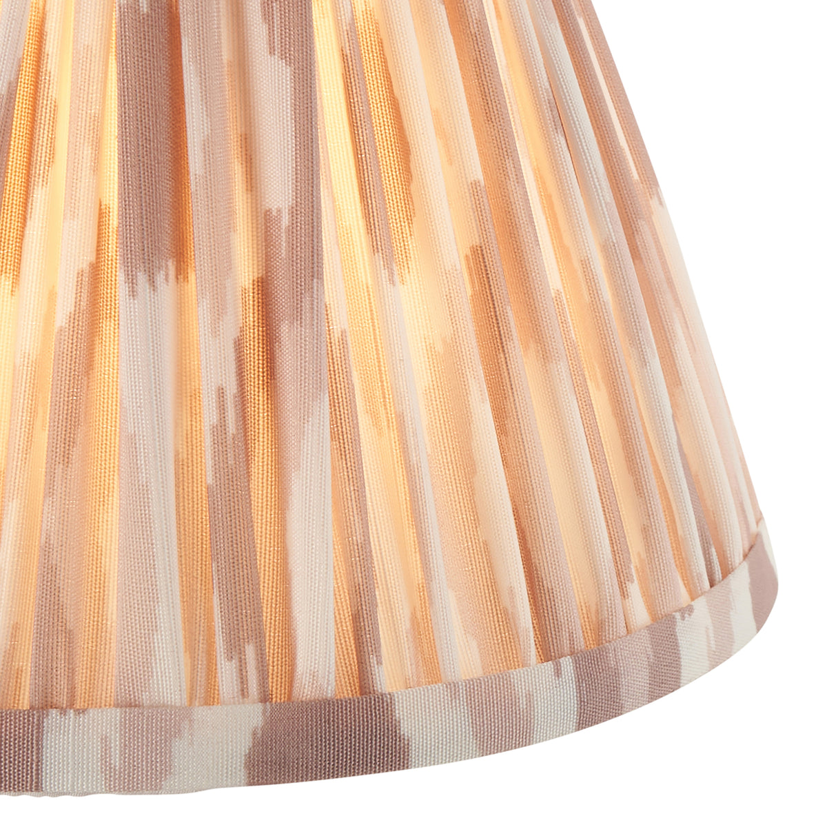Close-up of the pleated natural ikat fabric and rolled hem of the lampshade