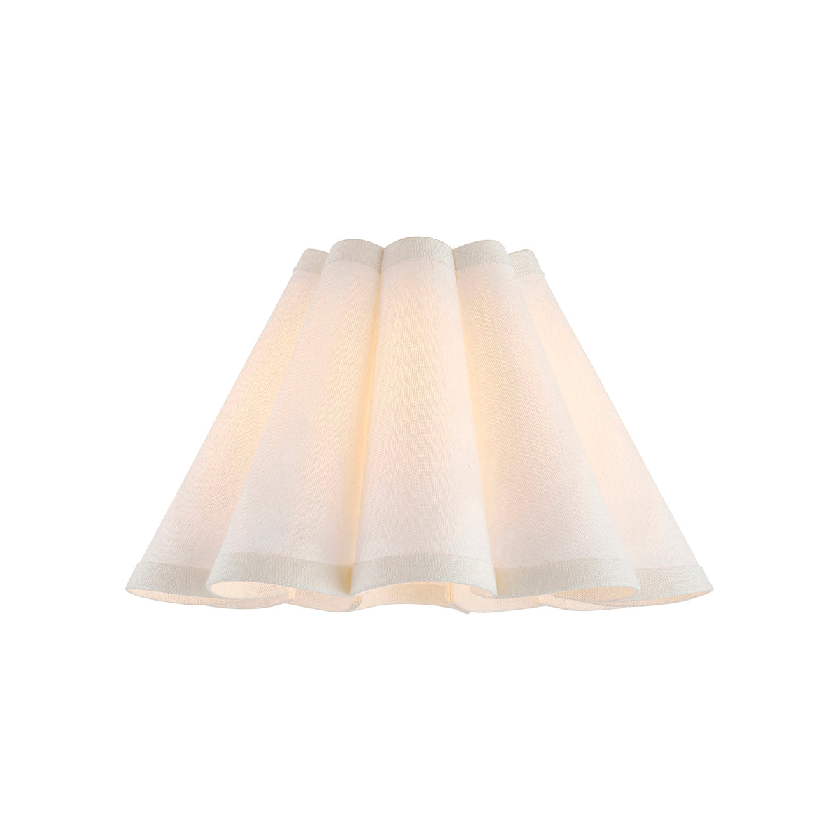 Ayla tapered scalloped lamp shade lit from within, glowing warm cream