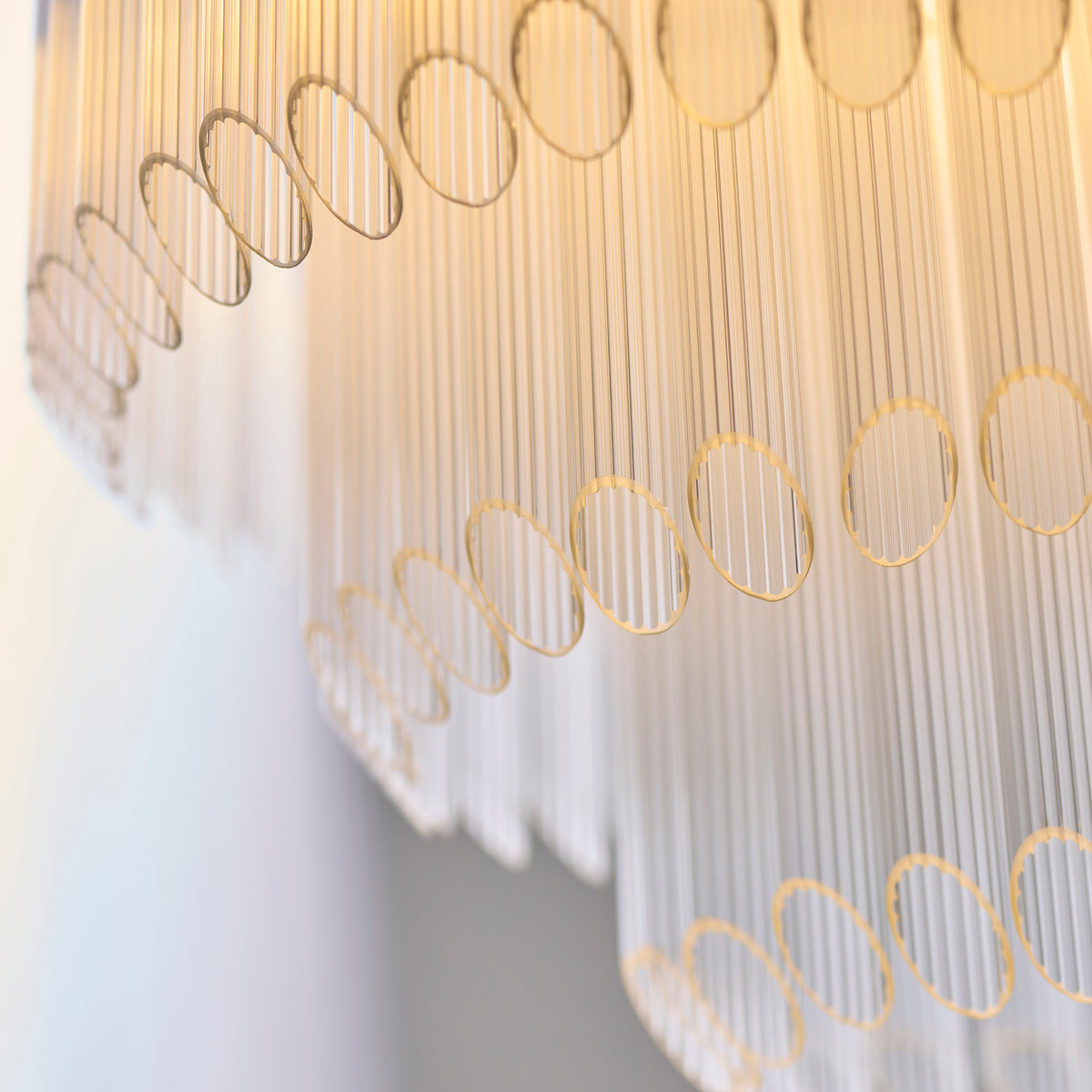 Close-up of the layered ribbed glass rods and brass rings on the Montpellier chandelier