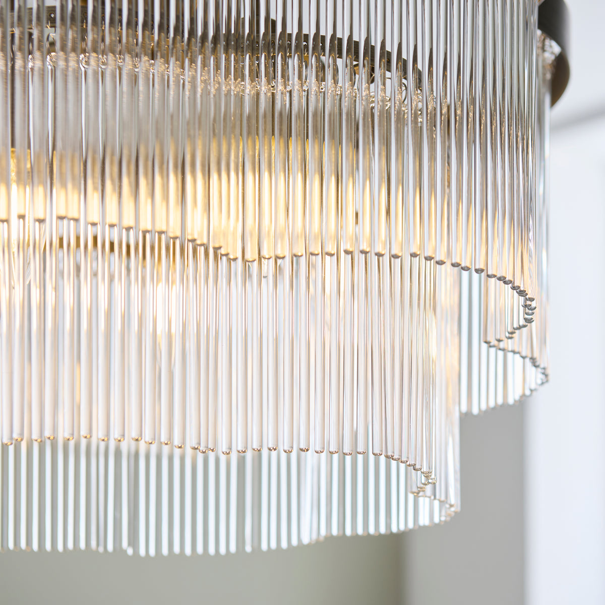 Underside detail of the Lucille chandelier's layered clear glass rod tiers