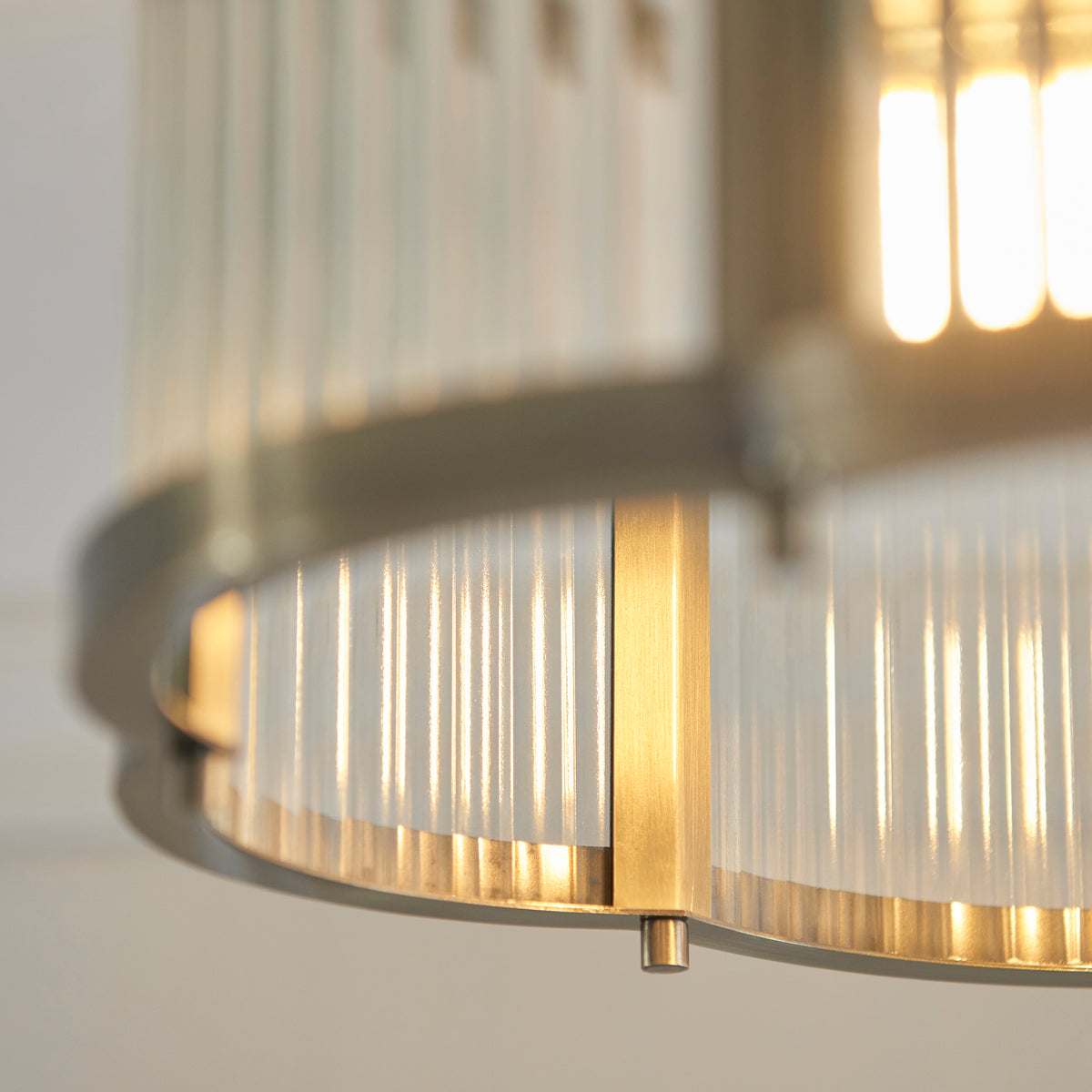 Detail of the antique brass ring and ribbed glass panels on the Ridgeton Scallop ceiling light