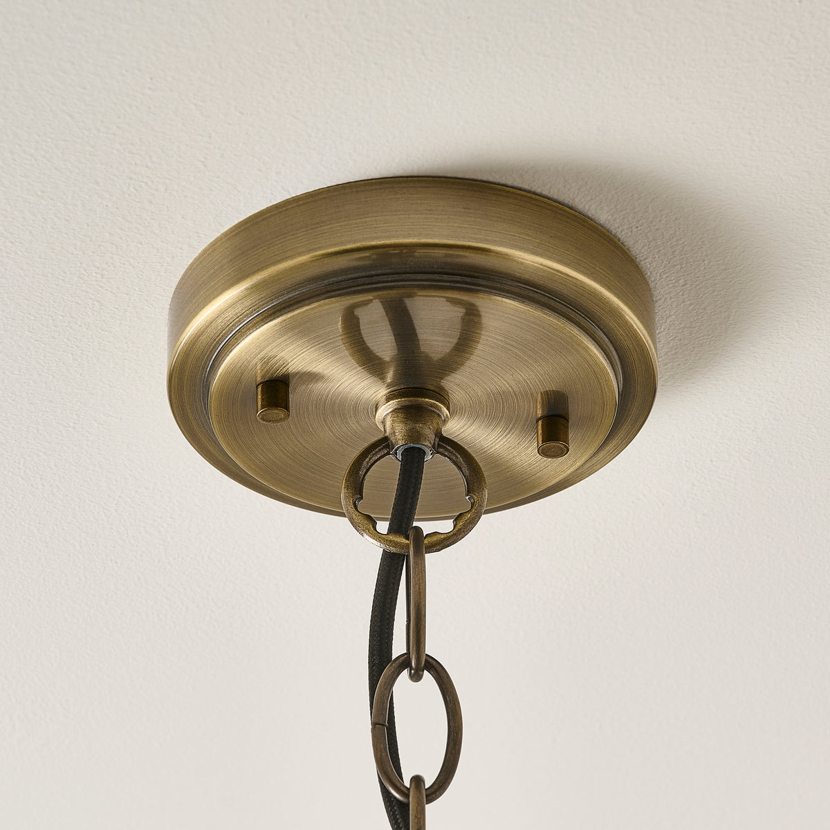 Hebden antique brass pendant light with clear glass cylinder shade, cut out on white
