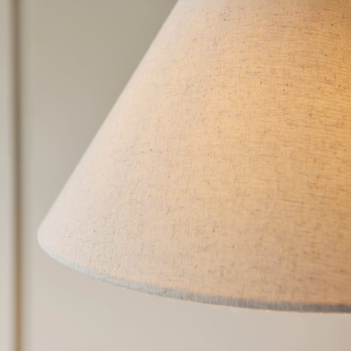 Close-up of the natural linen weave on the Wallbridge floor lamp's coolie shade
