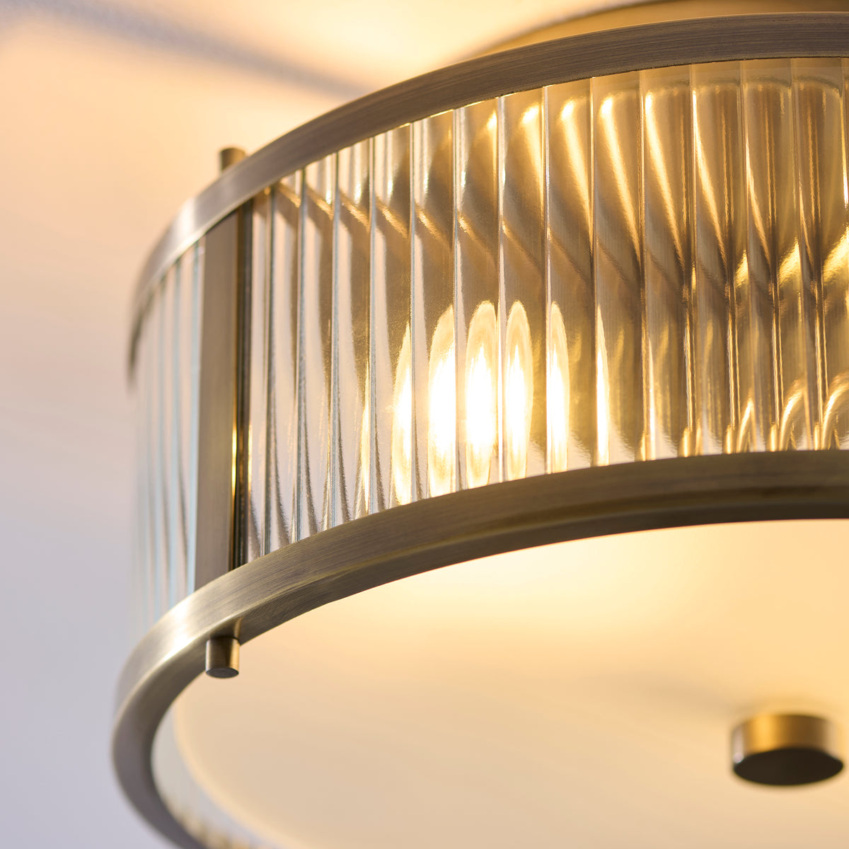 Close-up of the Ridgeton light's ribbed clear glass rods within an antique brass frame