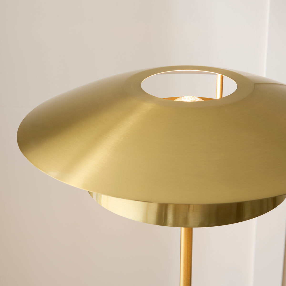 Detail of the circular aperture in the Lyon brass shade showing the lamp within