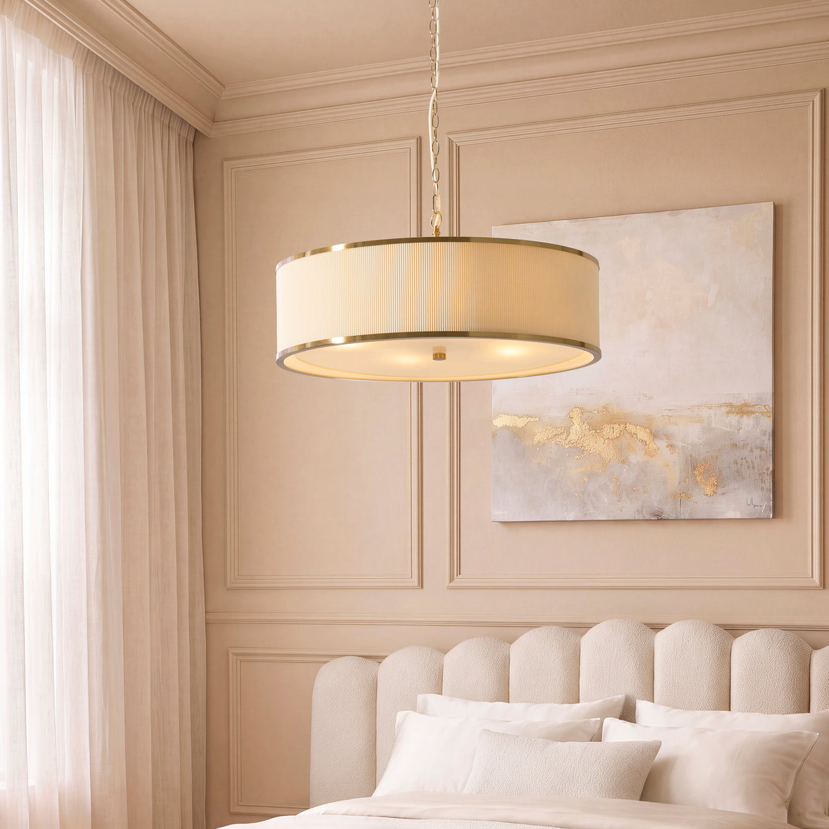 Lexi pleated pendant lit over a cream bed in a beige panelled bedroom with gold abstract artwork