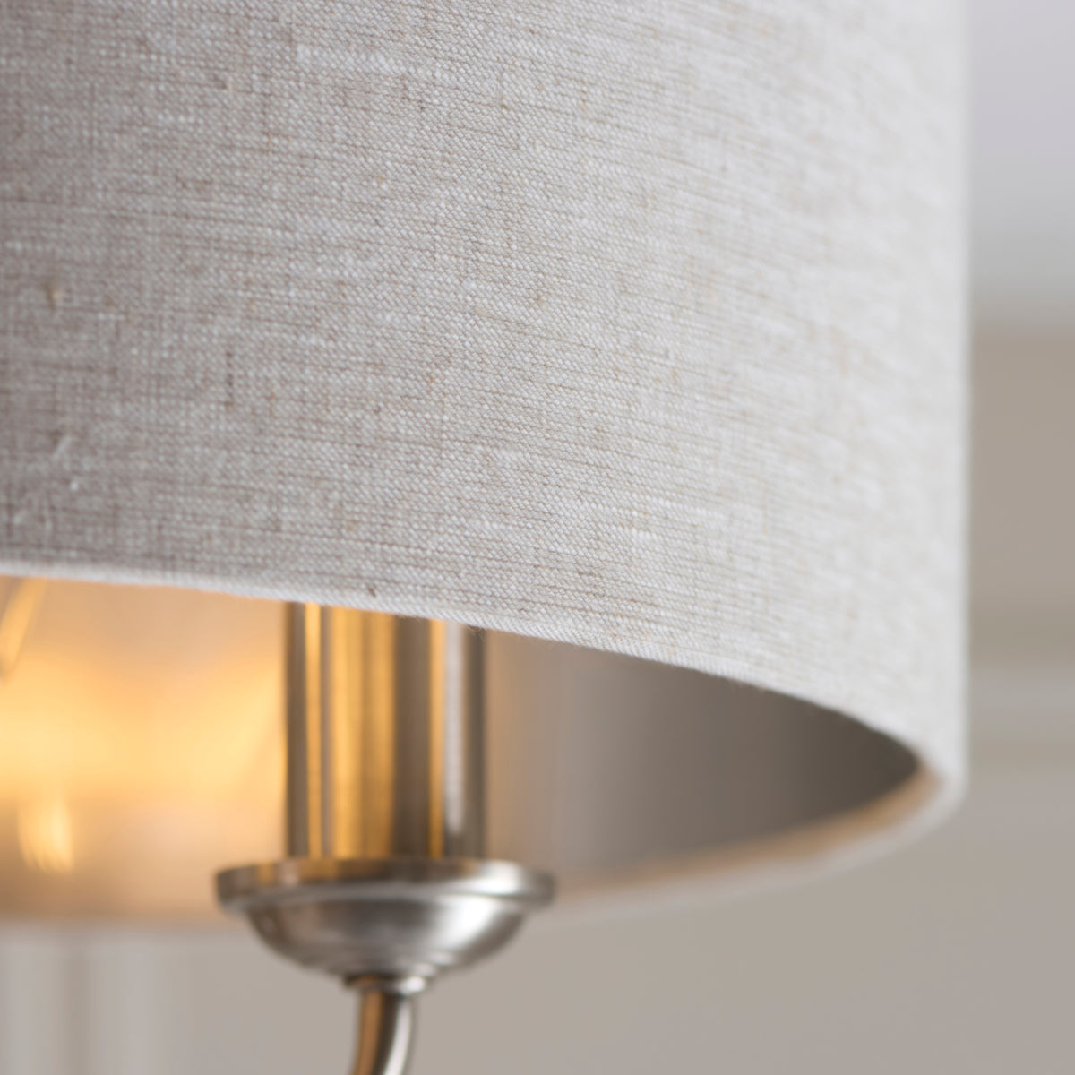 Detail of the Highclere natural linen shade edge with the bright chrome inner lining