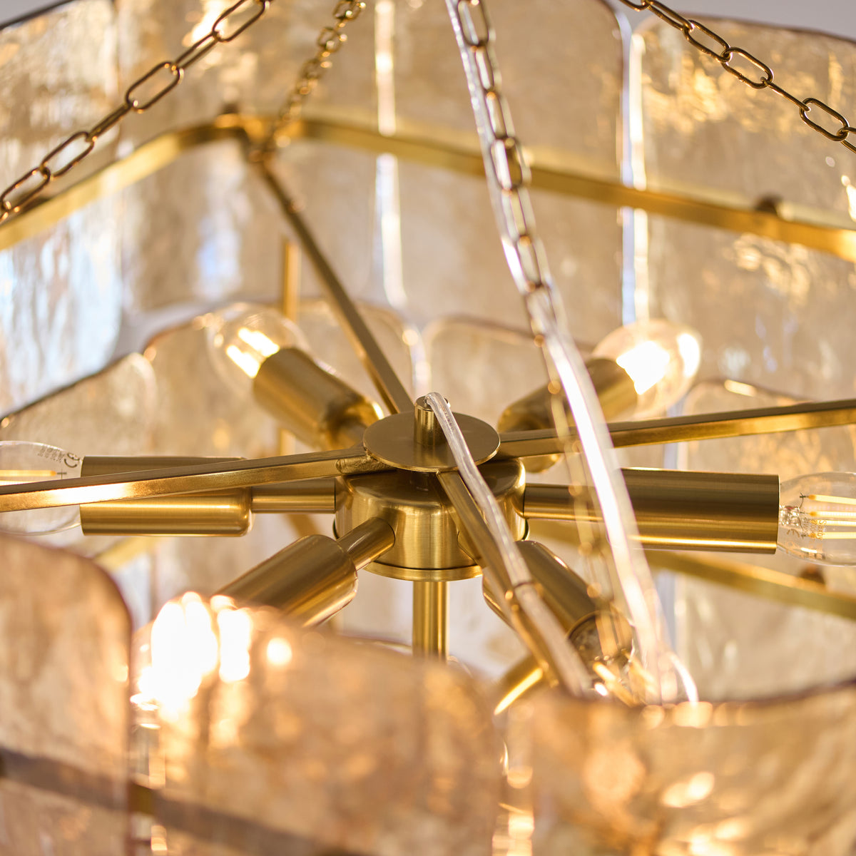 Interior of the Venice pendant showing brass lamp holders and lit filament bulbs