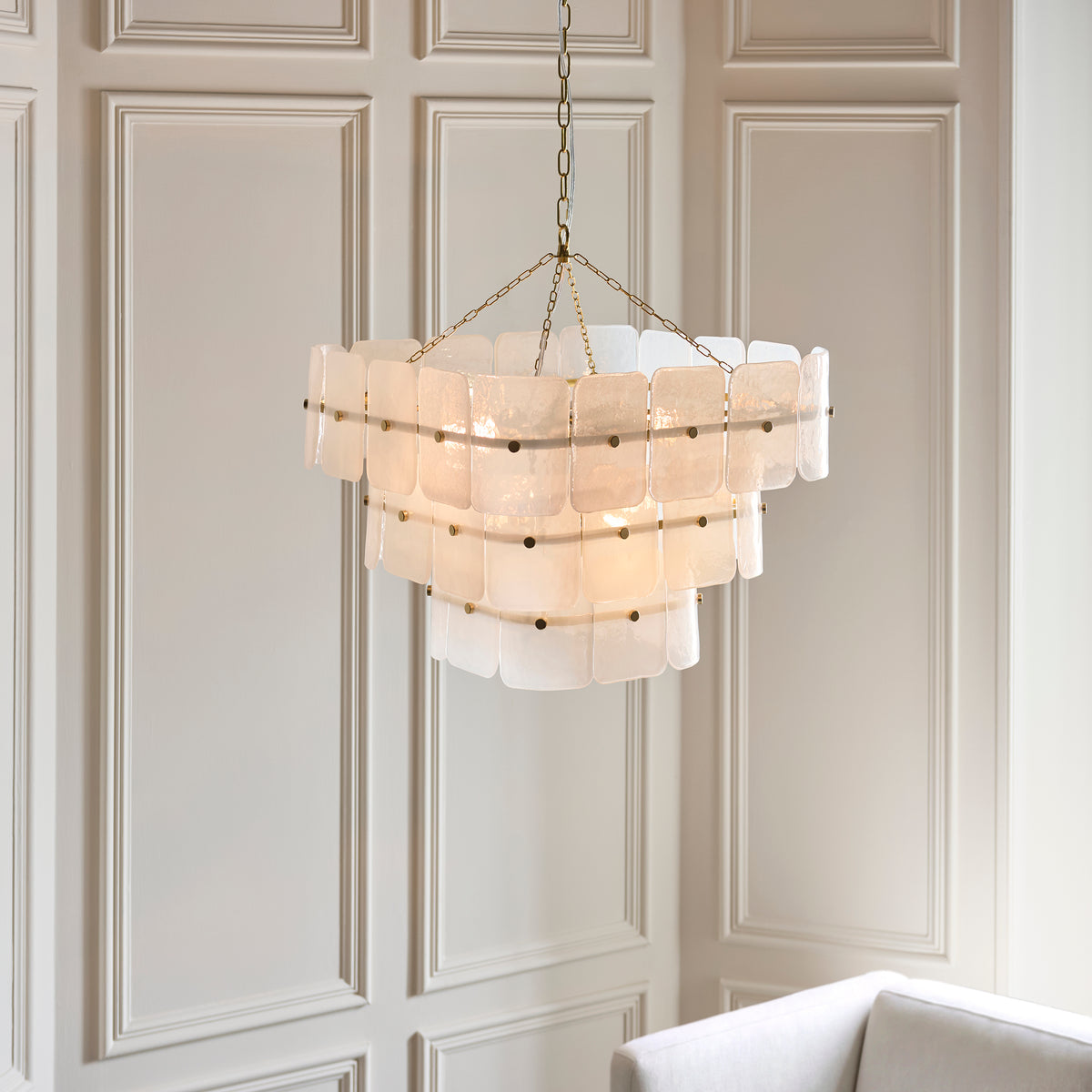 Angled view of the Venice 10 light chandelier showing its stepped tiers of mottled white glass