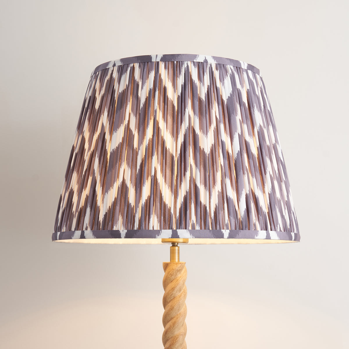 Close-up of the pleated pearl grey zigzag fabric shade on the Twist floor lamp