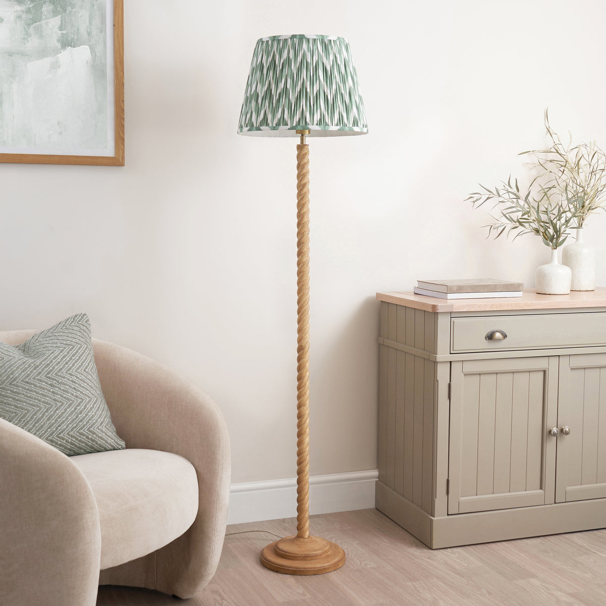 Oak effect twisted floor lamp with green zigzag shade in a bright neutral living room