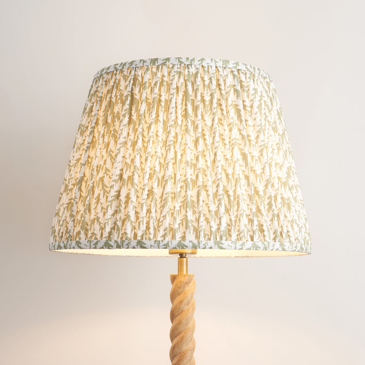 Close-up of the pleated green leaf print fabric shade on the Twist & Leaf floor lamp