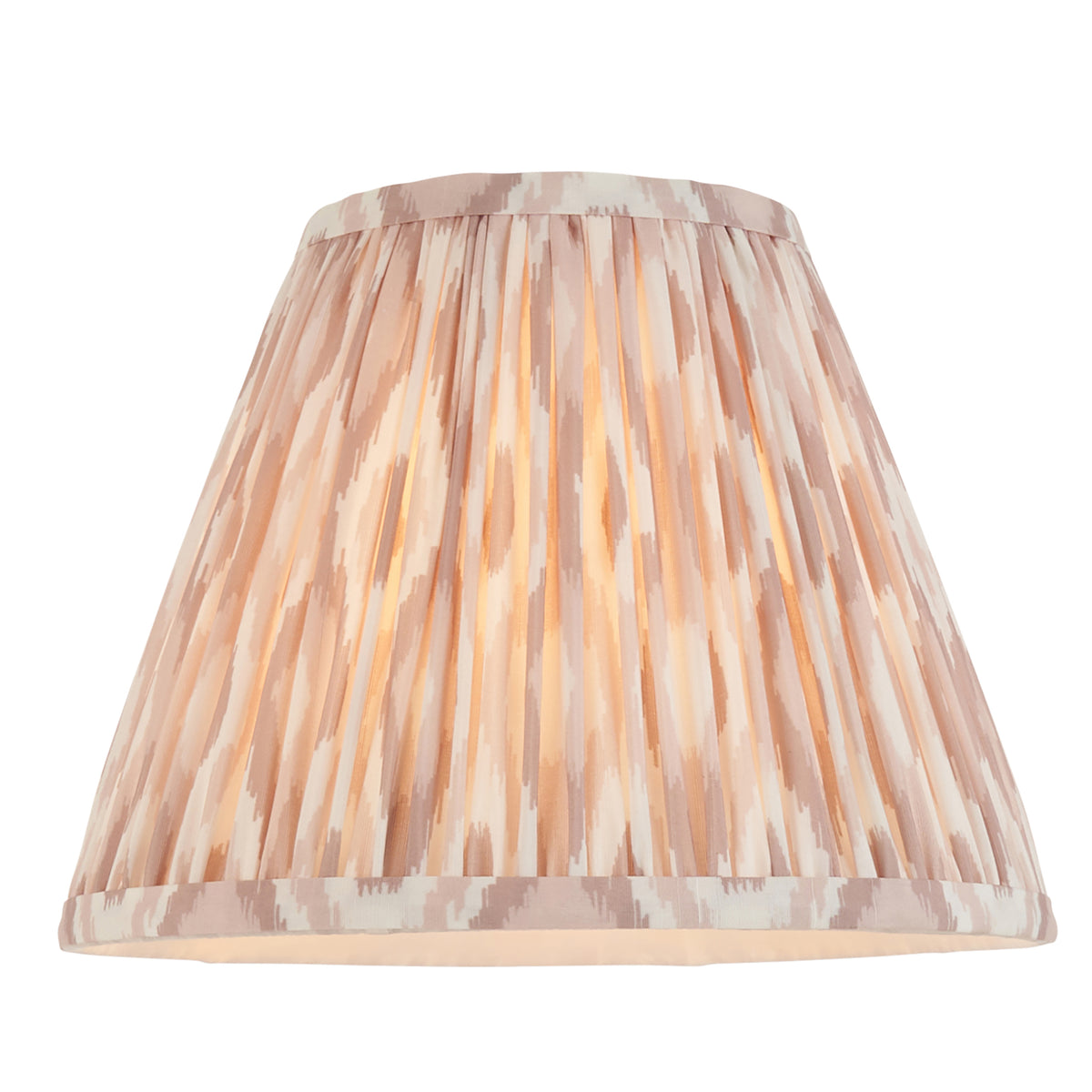 Pleated neutral ikat empire shade shown alone, lit from within to reveal its soft print