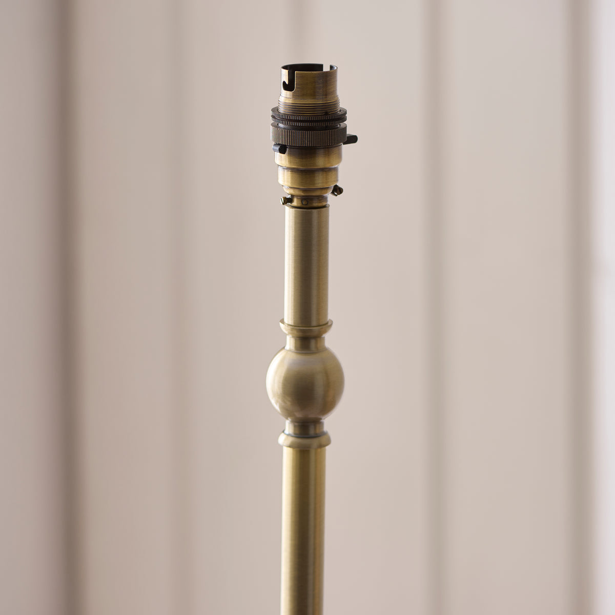 Detail of the Jericho lamp's antique brass turned stem and bayonet lampholder