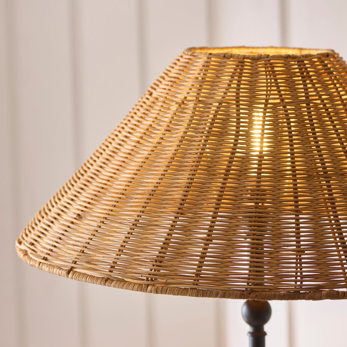 Close-up of the Jericho floor lamp's natural rattan weave with warm light shining through