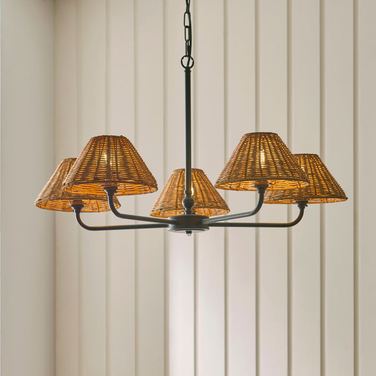 Jericho black chandelier with five rattan shades against cream tongue-and-groove panelling