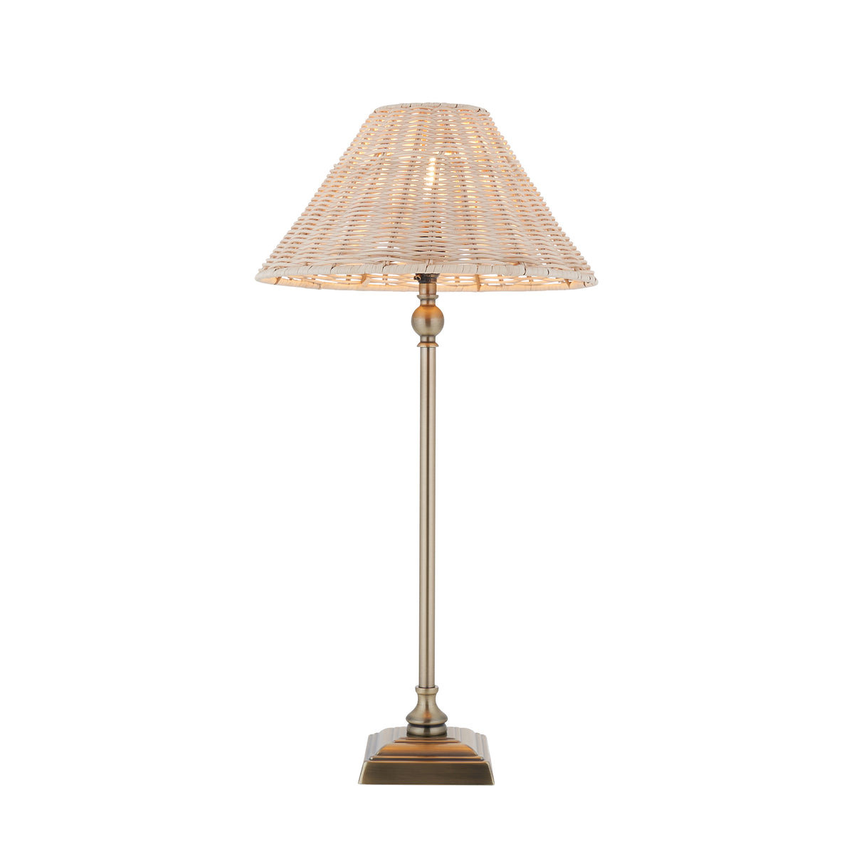 Jericho antique brass table lamp with tall slim stem and natural woven rattan coolie shade on white