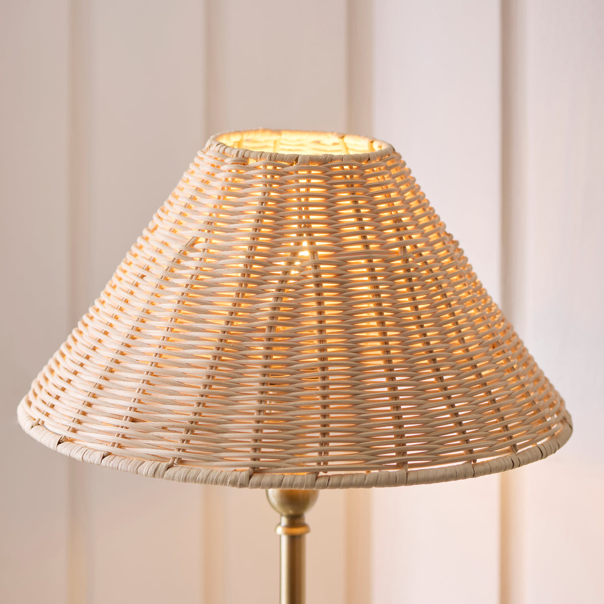 Close view of the Jericho lamp's natural rattan coolie shade with warm light through the weave