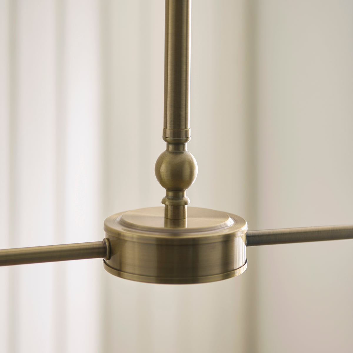 Antique brass hub and arm detail of the Jericho linear pendant