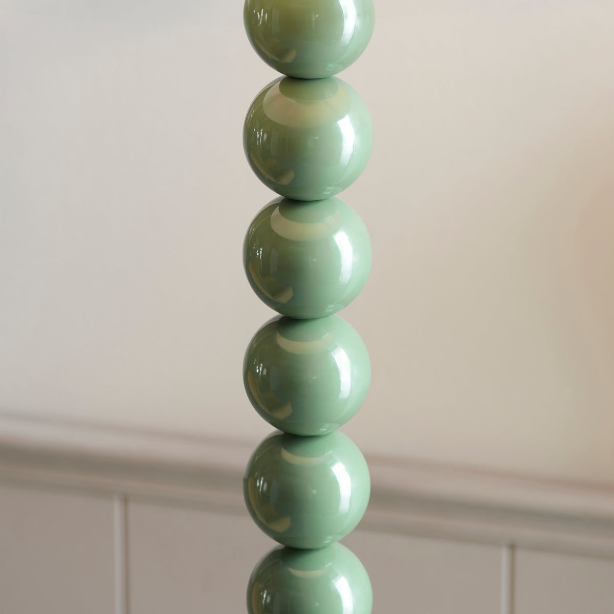 Close-up of the polished green ceramic-look ball stem of the Higgledy floor lamp