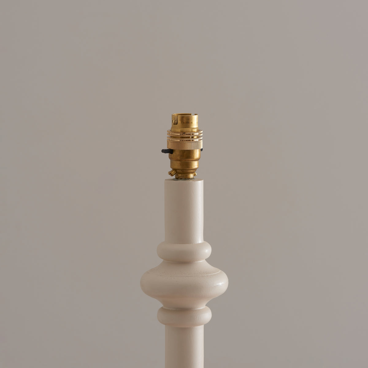 Close-up of the brass lampholder on the almond white Carnaby lamp stem