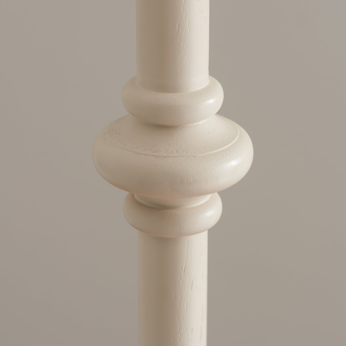 Detail of a turned collar on the almond white wooden Carnaby floor lamp stem