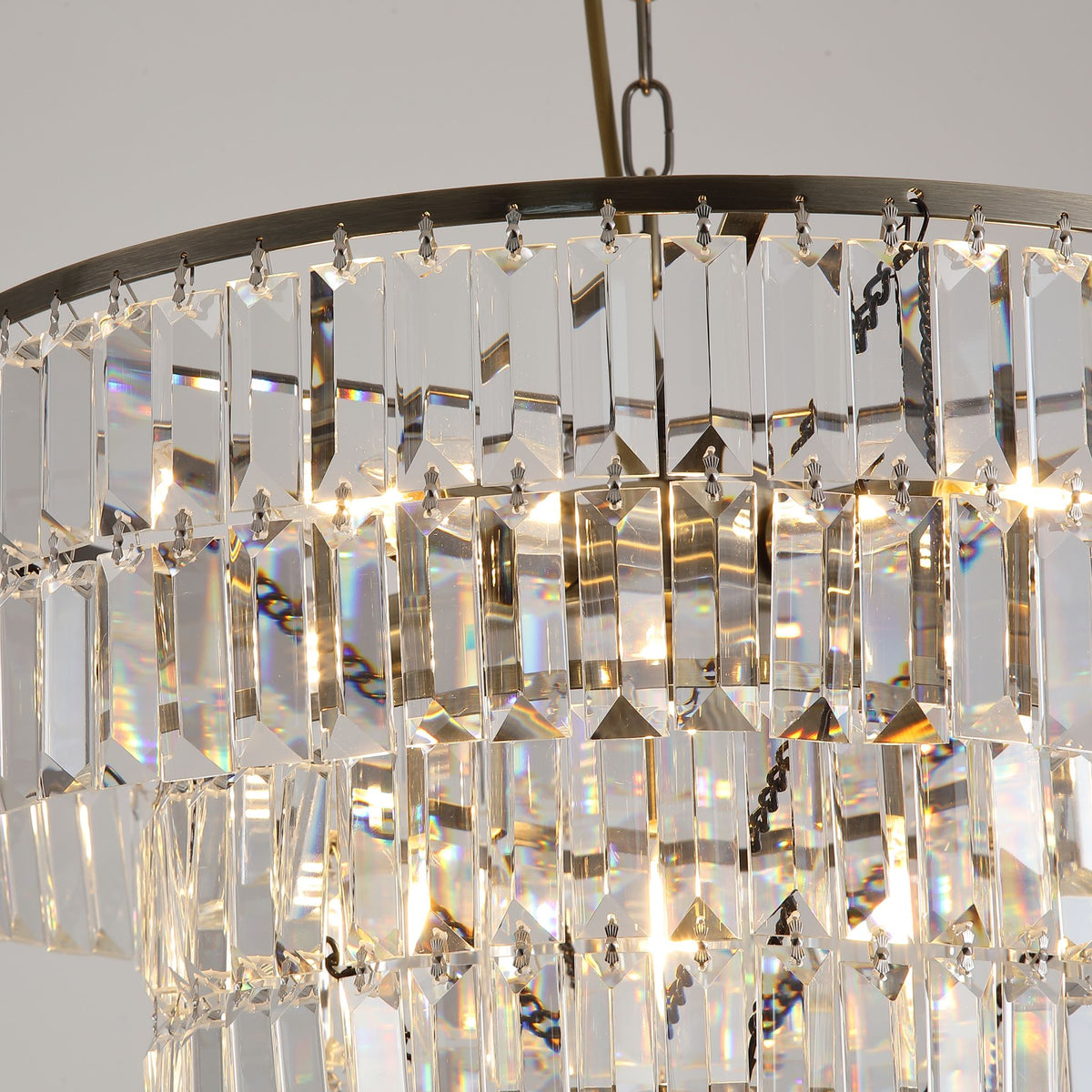 Detail of the Empire chandelier's brass frame chains and clear crystal drops