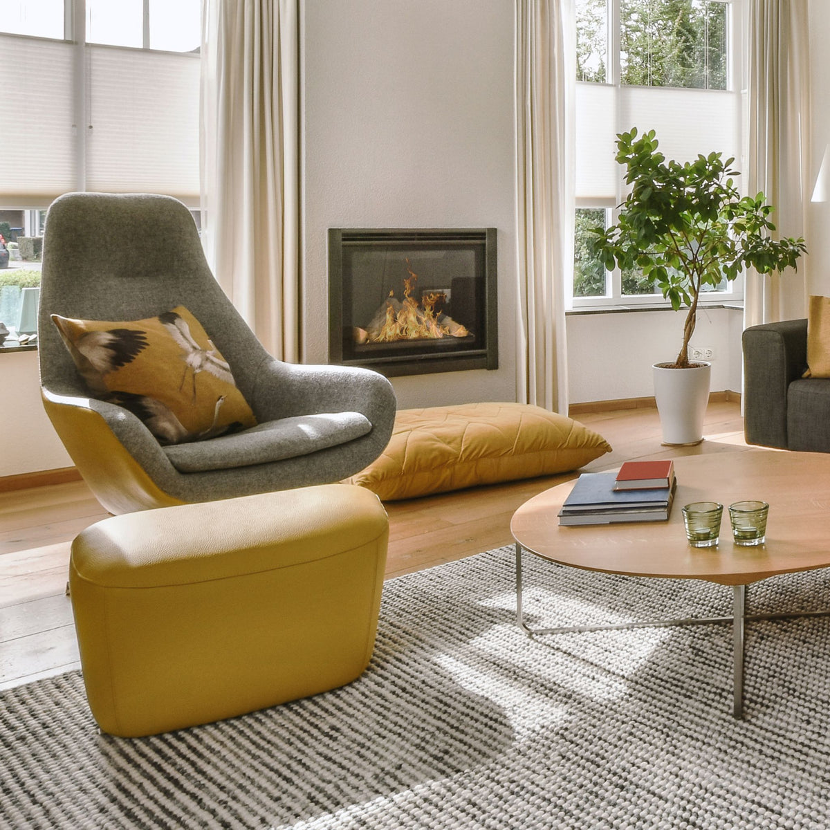 Bright living room with the Empire crystal chandelier above a yellow chair and fireplace