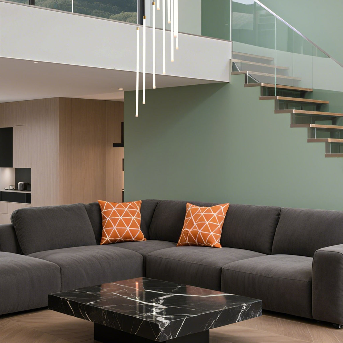 Flare brass tube pendant over a stairwell in an open living room with grey corner sofa