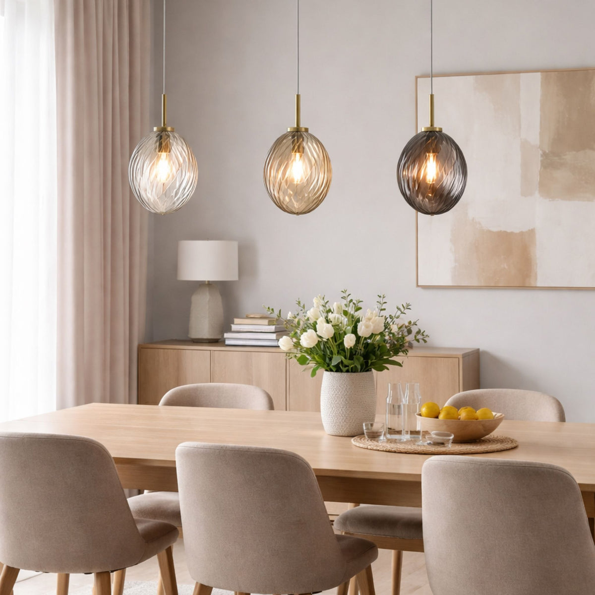 Whirl brass pendants above an oak dining table with beige chairs and sideboard in a bright dining room