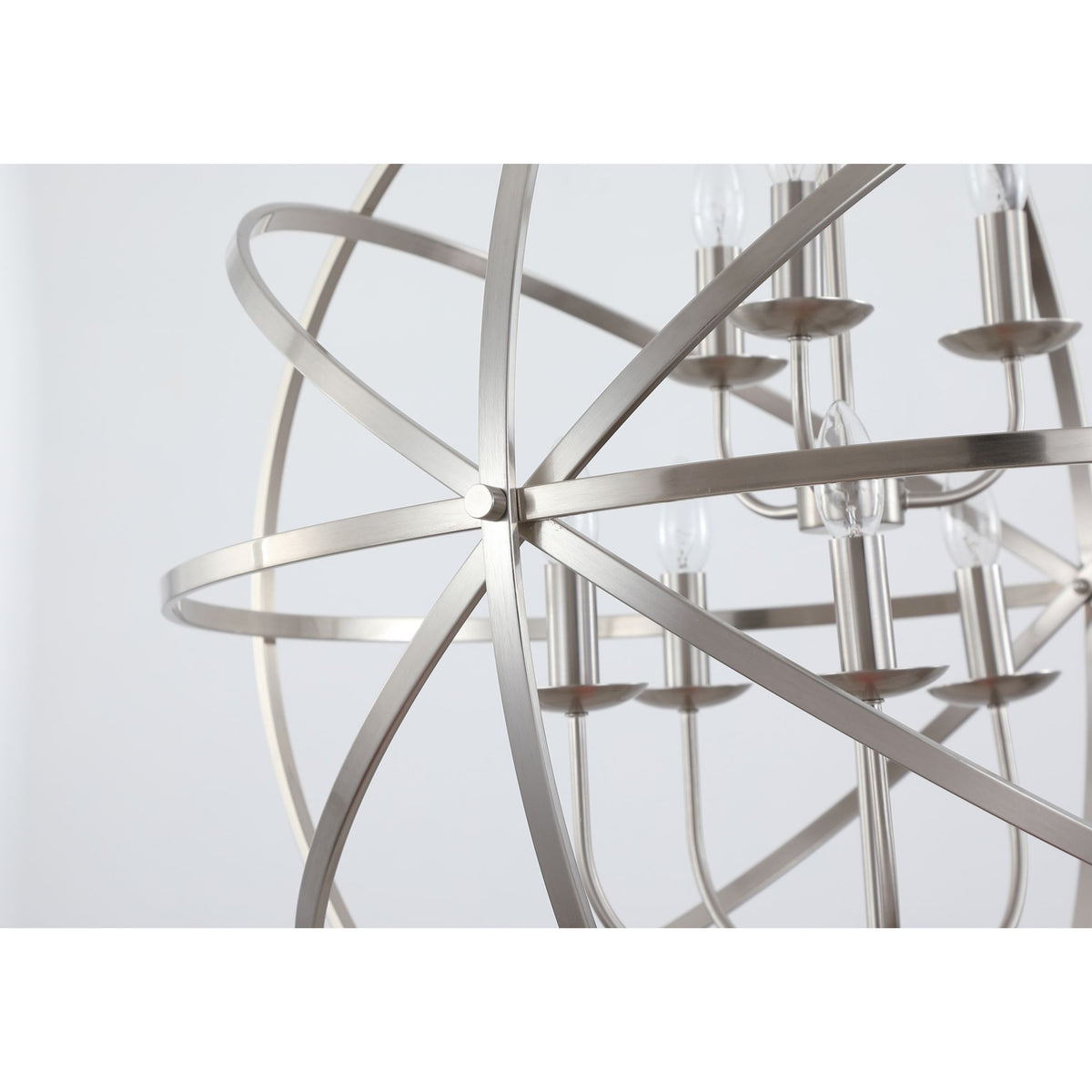 Close-up of the Orbit chandelier's crossing silver bands and inner candle lamp holders