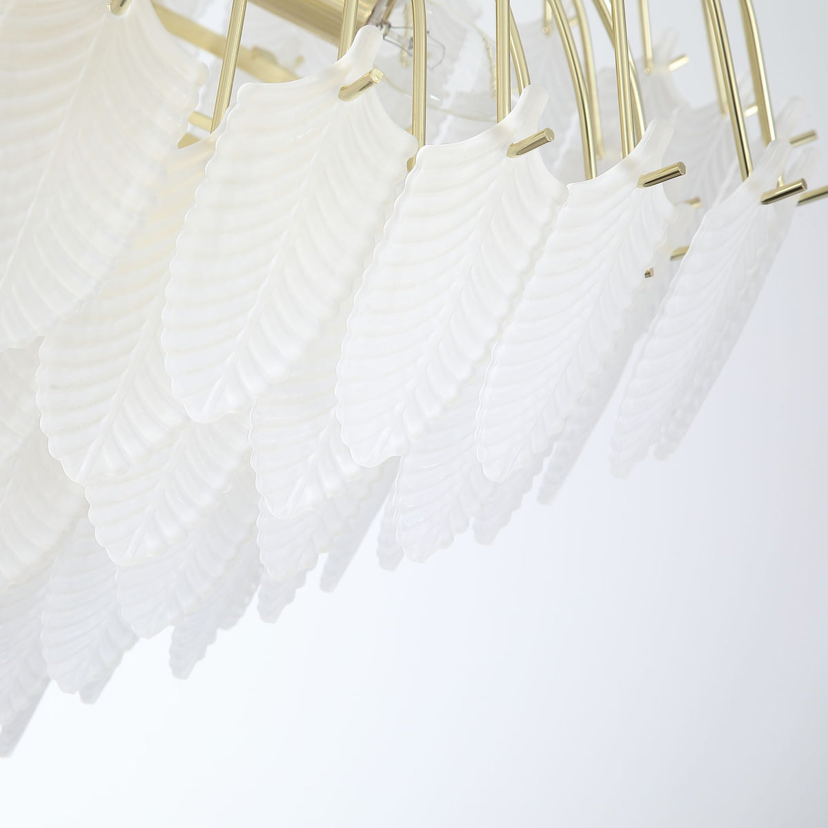 Detail of Feather chandelier's overlapping frosted glass feather panels on slender brass arms