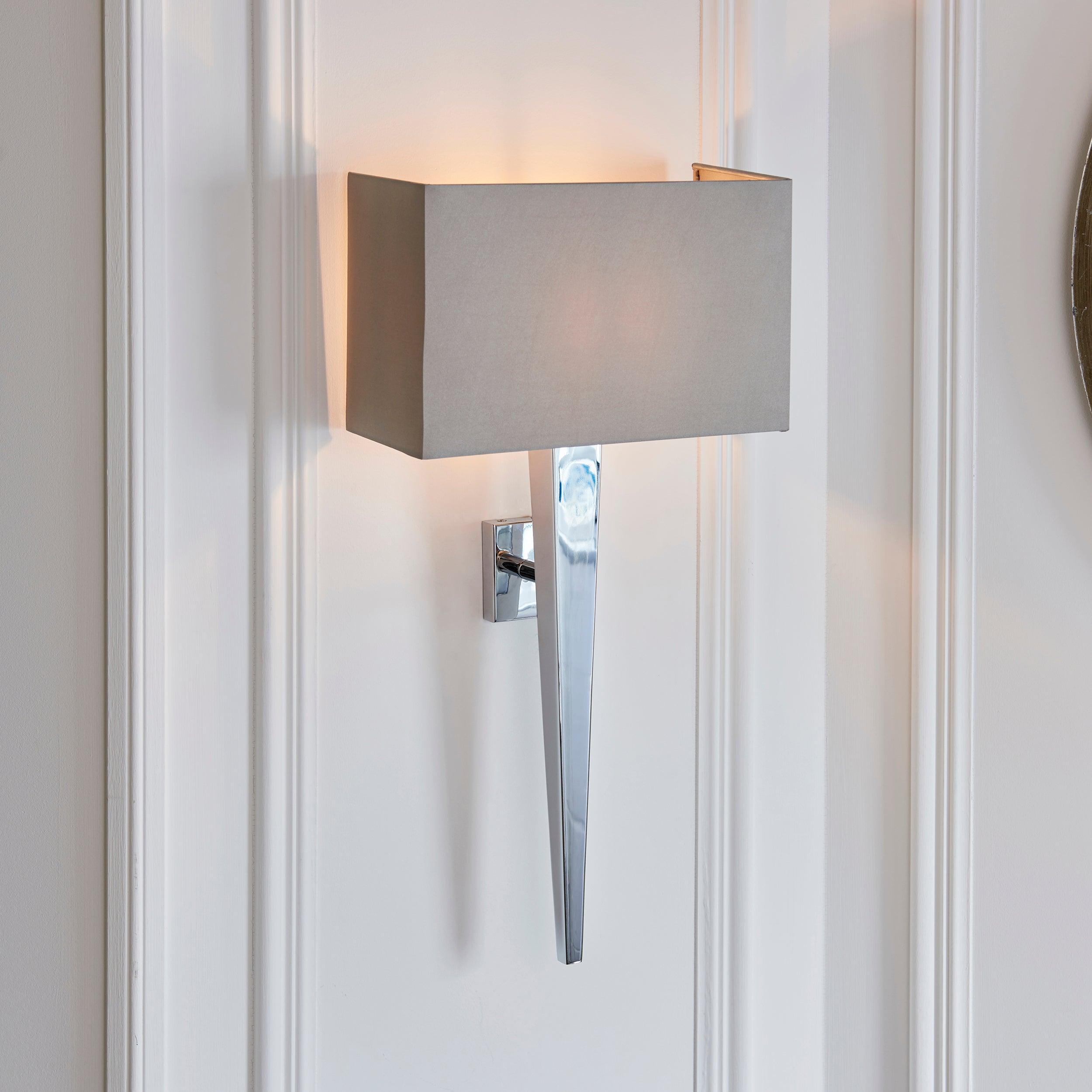 moreto chrome finish and grey faux silk wall light by Endon Lighting Bedroom Close Up Image