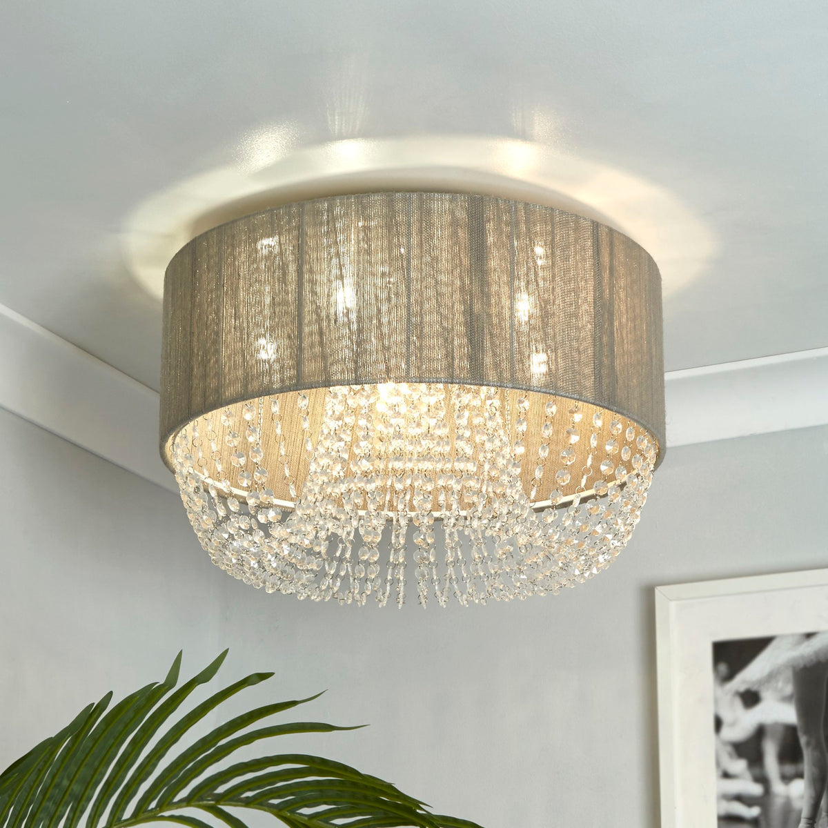 Bellano beaded drum ceiling light on a white coved ceiling above a plant and framed print
