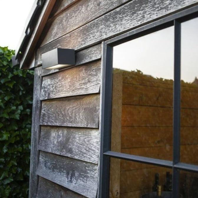 Lutec Gemini Outdoor LED Up & Down Brick Wall Light In Dark Grey 5189102118 attached to a shed