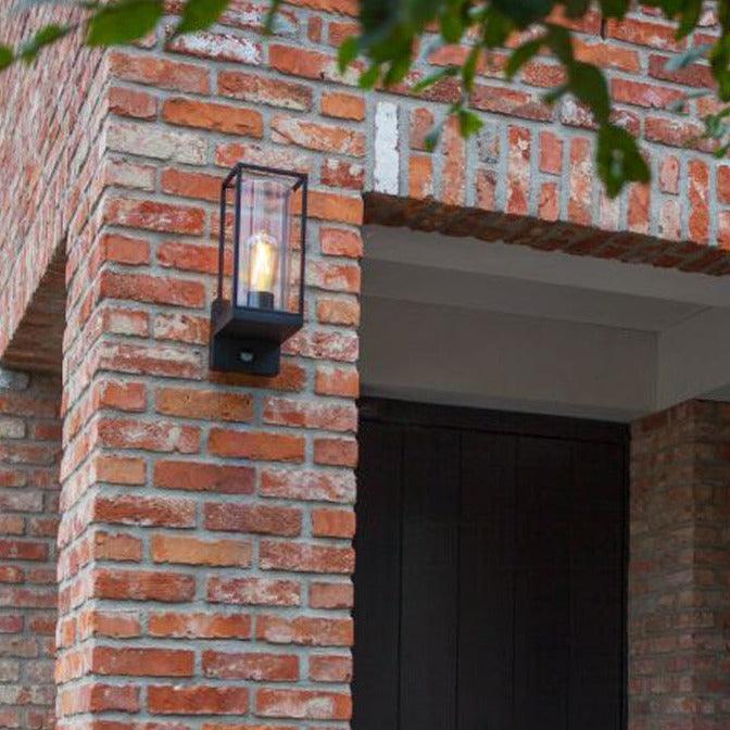 Lutec Flair PIR Outdoor Wall Light In Matt Black 5288802012 fixed to an outside wall