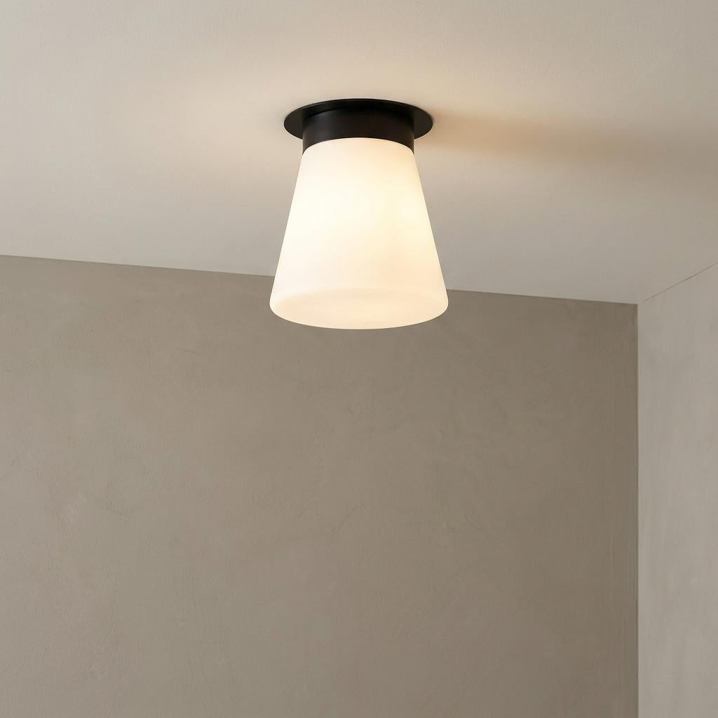 Albers Black Flush Ceiling Light with a black mount and a frosted white conical shade, mounted to a white ceiling.