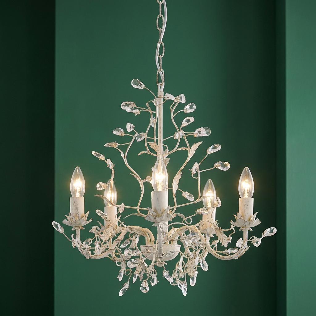 Almandite 5-light chandelier in cream gold with crystal droplets and branch motifs against a green wall.