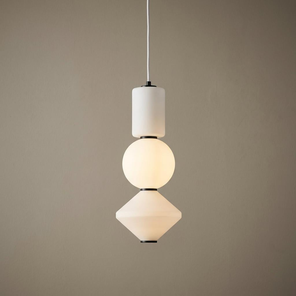 Modern LED pendant light featuring stacked frosted white glass cylinder, sphere, and diamond shapes.