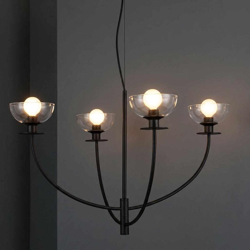 Alora Mood Sylvia 4-light black chandelier with clear bowl glass shades and glowing bulbs against a gray background.